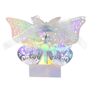 Detail of laser-cut butterfly wedding favor box with iridescent finish and white ribbon bow