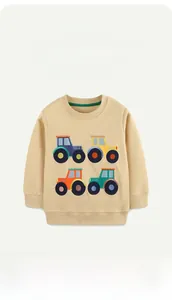 Close-up of ribbed crewneck and colorful cartoon tractor embroidery on cotton sweatshirt