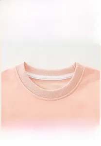 Detail of a pink cotton sweatshirt showing the comfortable ribbed crew neck collar