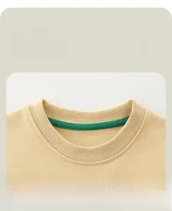 Detail of reinforced ribbed crew neck on beige cotton sweatshirt with green inner binding