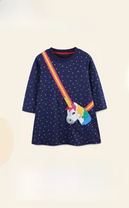 Detail of navy girls' dress with golden stars and colorful unicorn embroidery patch