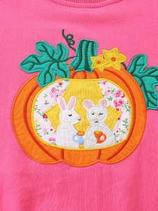 Pink girl's Halloween sweatshirt featuring embroidered pumpkin with rabbit and floral details