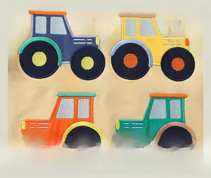 Detail of colorful tractor embroidery on beige cotton fabric for children's sweatshirt