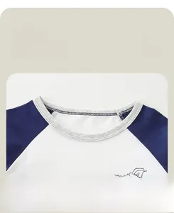 Close-up of comfortable ribbed crew neck and blue raglan sleeve with cartoon dog print
