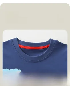 Macro detail of navy blue crew neck collar with red reinforced seam tape on cotton tee