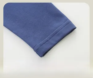 Detailed macro view of gray-blue knit cotton sleeve cuff with double-needle stitching