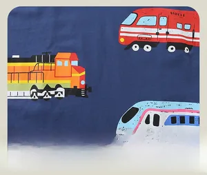 Detailed close-up of dark blue kids t-shirt fabric with colorful cartoon train prints
