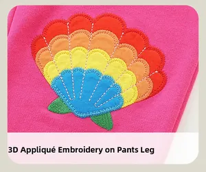 Détail de la broderie arc-en-ciel 3D avec coutures de qualité sur le pantalon rose fille
