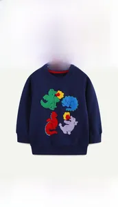 Detail of colorful dinosaur towel embroidery on navy blue cotton sweatshirt