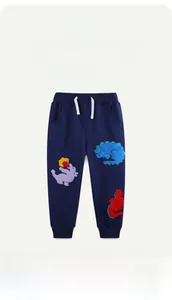 Detailed view of navy blue kids joggers featuring colorful dinosaur towel embroidery