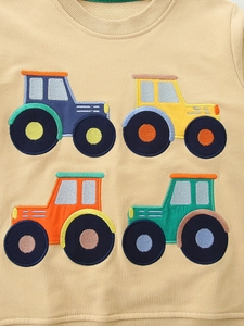Kids cream sweatshirt with colorful tractor embroidery made of soft knitted cotton fabric