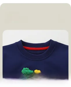 Detail of navy cotton sweatshirt with rib knit neckline and colorful dinosaur embroidery