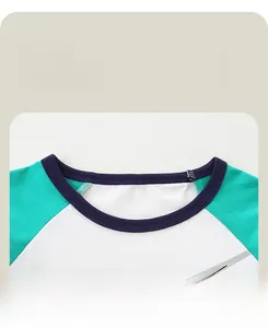 Detail view of comfortable navy crew neck on a cotton raglan sleeve T-shirt for boys
