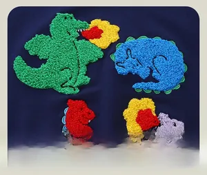 Close-up of vibrant cartoon dinosaur towel embroidery on navy blue cotton sweatshirt
