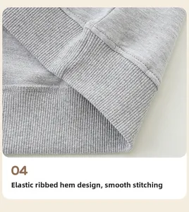 Détail de l'ourlet élastique côtelé et des coutures soignées du sweat-shirt gris
