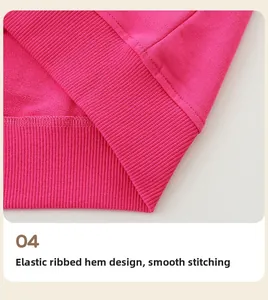 Detailed macro view of the elastic ribbed hem and flat stitching on the pink sweatshirt