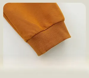 Close-up of ribbed elastic cuffs on yellow kids' sports trousers with high-quality knit texture