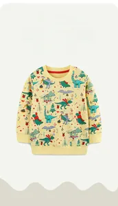 Detail of Christmas dinosaur pattern on yellow long-sleeve cotton sweatshirt for kids