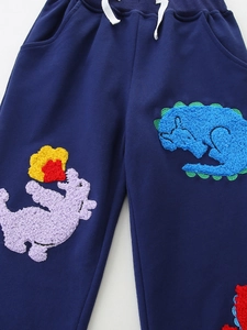 Navy blue kids joggers featuring colorful 3D textured dinosaur embroidery and white drawstring