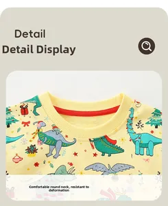 Detail of children's crewneck sweatshirt featuring festive dinosaur and Christmas tree prints