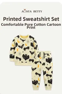 Detail of soft cotton kids Halloween outfit with cartoon bat and moon prints