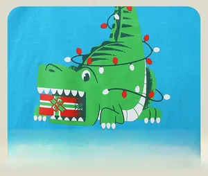 Detail of Christmas green crocodile print with festive lights on a blue long sleeve shirt