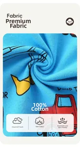 Detailed view of 100% cotton blue knit fabric with cartoon construction truck print