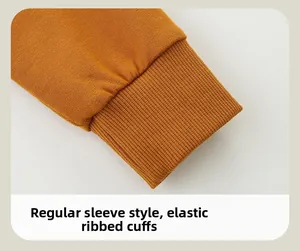 Macro detail of ginger yellow ribbed elastic cuffs on long sleeve dinosaur sweatshirt