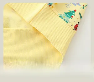 Detail of ribbed hem on boys' Christmas sweatshirt with festive prints and stitching