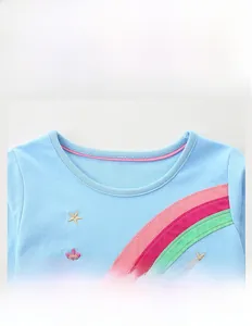 Detail of baby girl blue cotton dress with colorful rainbow embroidery and pink neck trim