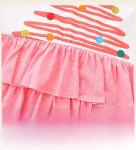 Detail showing the waistline of girl dress with pink polka dot ruffled layers and wavy pattern