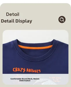 Detail of boys navy cotton T-shirt featuring a ribbed crew neck and orange print