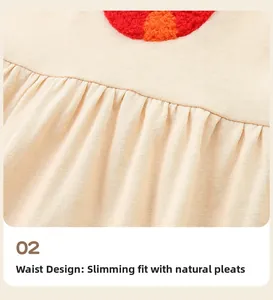 Detail of knitted beige girls dress featuring waist pleats and plush heart embroidery