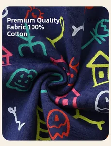 Détail du tissu 100% coton avec des motifs de monstres colorés sur un fond bleu marine