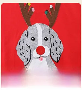 Detailed close-up of Christmas puppy embroidery with appliqué on red cotton sweatshirt