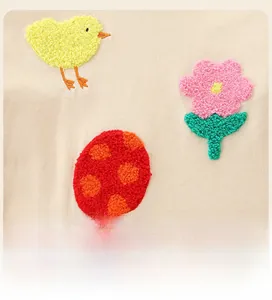 Detailed view of 3D towel embroidery with cute chicks and flowers on cotton dress