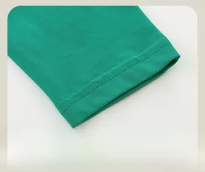 Detailed macro view of green cotton T-shirt cuffs featuring reinforced double stitching