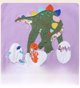 Detail of purple cotton sweatshirt featuring cute dinosaur applique and embroidery