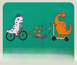 Detailed close-up of cartoon dinosaur prints on green cotton long sleeve T-shirt for boys