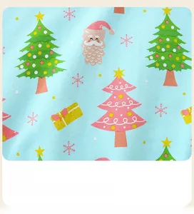 Close-up of kids sweatshirt fabric with cute Christmas trees and Santa Claus print pattern