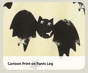 Detail of cartoon bat print on cream cotton pants leg with star patterns for kids