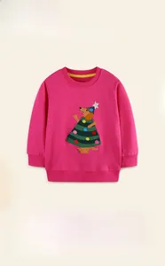 Detail of pink cotton girl's sweatshirt featuring a festive embroidered puppy pattern