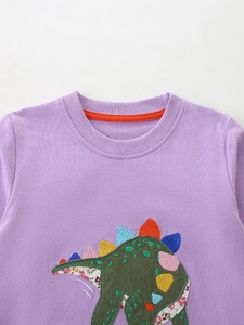 Lilac purple girl sweatshirt with colorful dinosaur applique and floral patchwork details