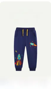 Detail of rocket embroidery and yellow drawstring on dark blue cotton kids joggers