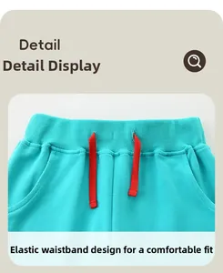Detail view of girls' turquoise sports pants with red elastic drawstring and ribbed waist
