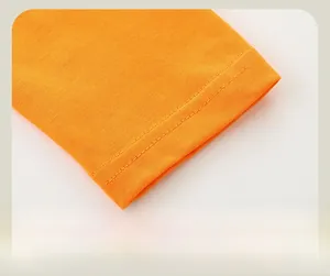 Detail of classic double-stitched cuffs on orange knit long sleeve dinosaur t-shirt
