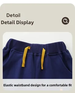 Detail of kids navy sports joggers featuring an elastic waistband and yellow drawstring
