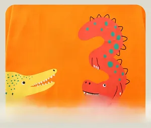 Close-up of vibrant orange cotton T-shirt featuring a cartoon crocodile print with I AM 3 text