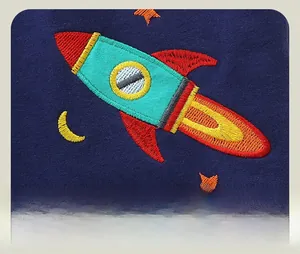 Detail of high-quality space rocket and stars embroidery on navy cotton kids joggers