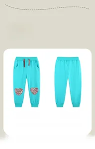 Front and back view of girls turquoise joggers with floral heart knee patches